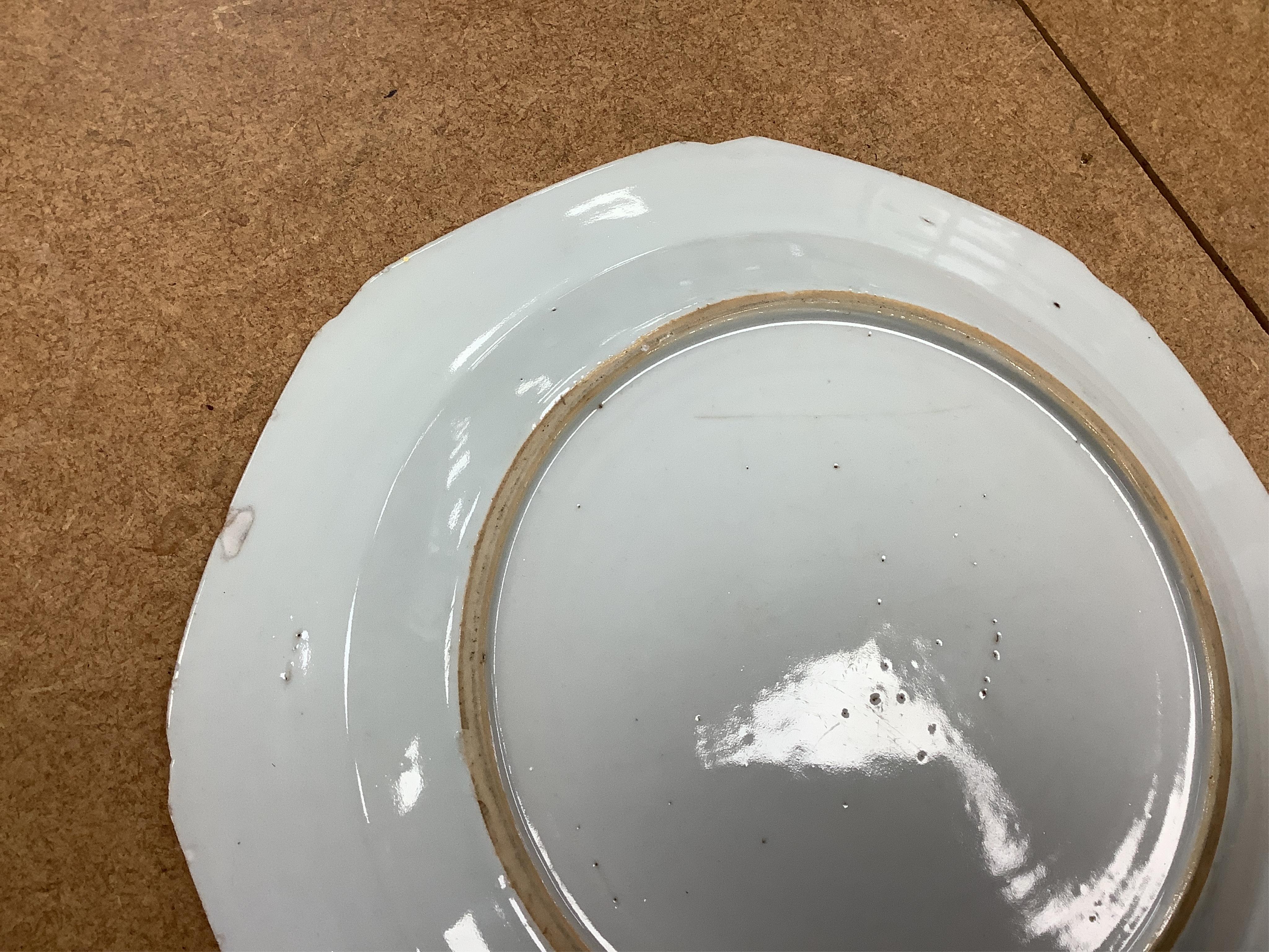 Three Chinese famille rose plates, Qianlong, including an armorial example, largest 22.5cm in diameter
